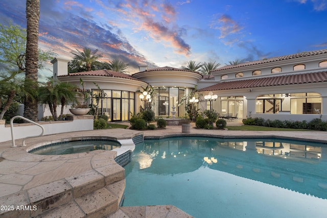 view of swimming pool with a patio area and a pool with connected hot tub