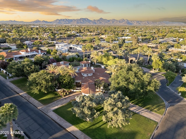view of property location with a mountain backdrop and nearby suburban area