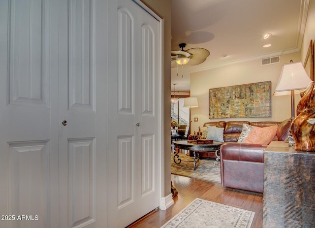 6900 E Princess Dr Unit 1176, Phoenix, AZ 85054 - living room with crown molding, wood finished floors, and ceiling fan