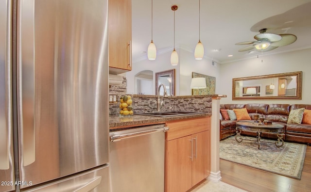 6900 E Princess Dr Unit 1176, Phoenix, AZ 85054 - kitchen with stainless steel appliances, a sink, ornamental molding, a ceiling fan, and decorative backsplash