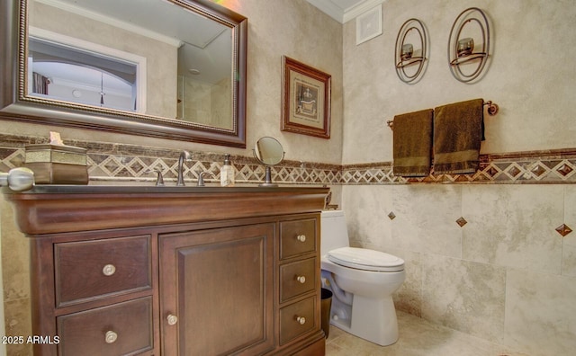 6900 E Princess Dr Unit 1176, Phoenix, AZ 85054 - bathroom with toilet, ornamental molding, vanity, tile walls, and wainscoting