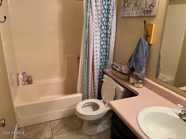 full bathroom featuring tile patterned floors, vanity, shower / bathtub combination with curtain, and toilet