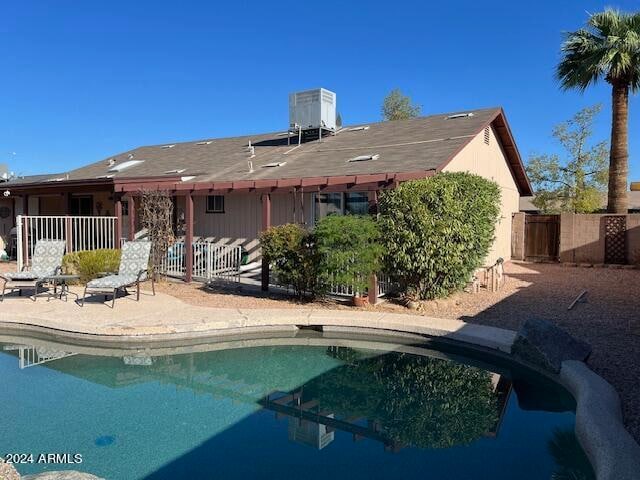 back of property with a patio area and central AC