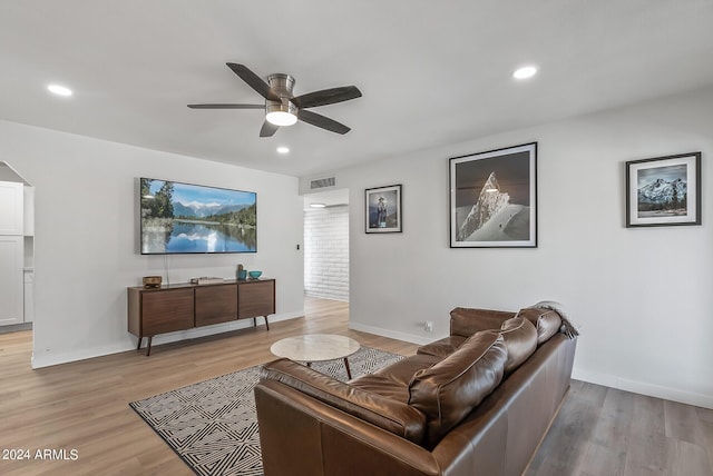 living room with ceiling fan and light wood-type flooring