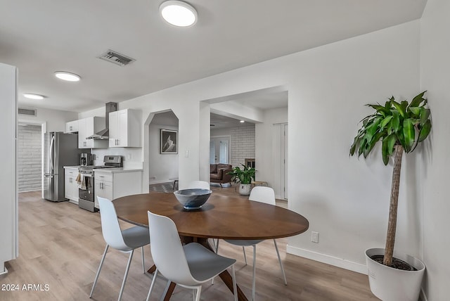 dining space with light hardwood / wood-style flooring