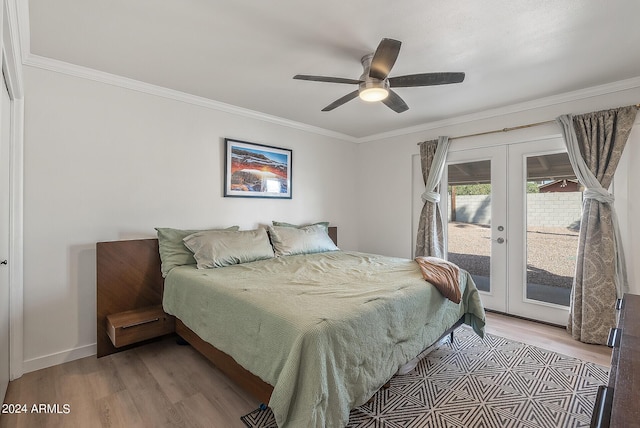 bedroom featuring light hardwood / wood-style floors, ceiling fan, access to outside, french doors, and crown molding