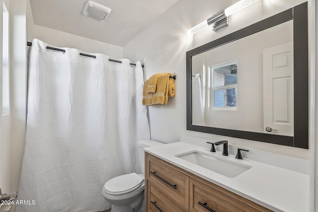 bathroom featuring toilet and vanity