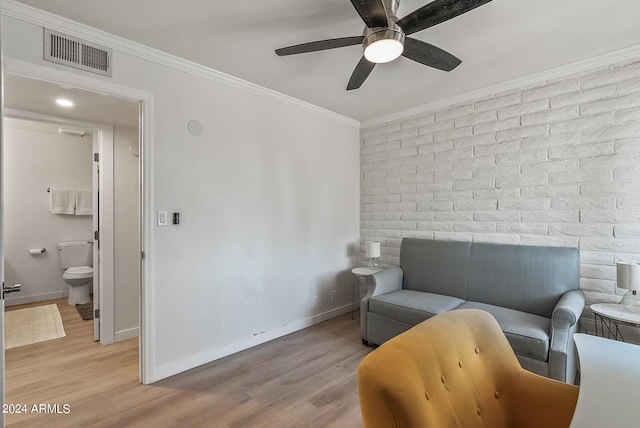 sitting room featuring ceiling fan, ornamental molding, and light hardwood / wood-style floors