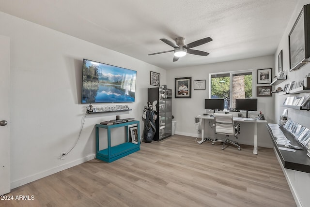 office space with ceiling fan, a textured ceiling, and light hardwood / wood-style flooring