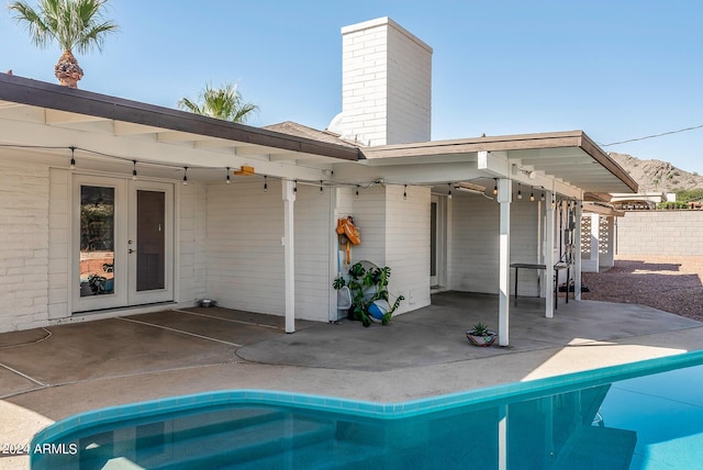 back of property featuring french doors and a patio