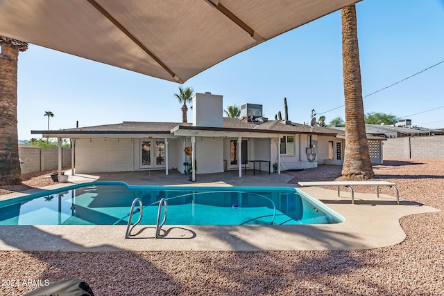 view of swimming pool with a patio area and central air condition unit