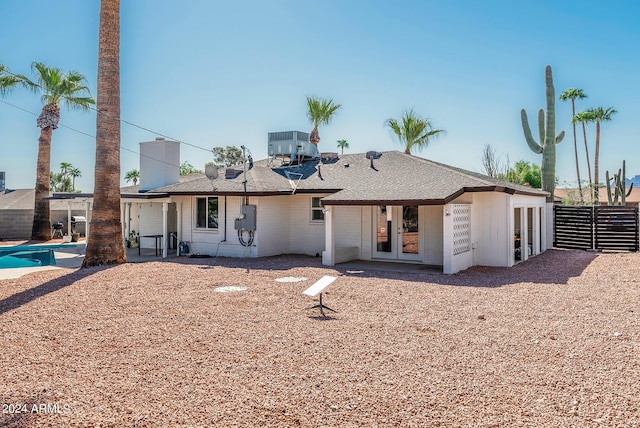 rear view of house featuring central AC and french doors