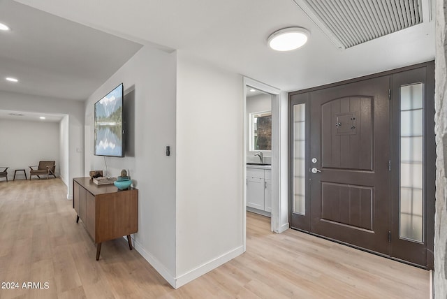 foyer entrance with light hardwood / wood-style floors