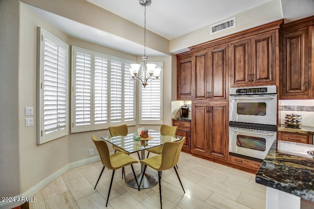 dining space with a notable chandelier