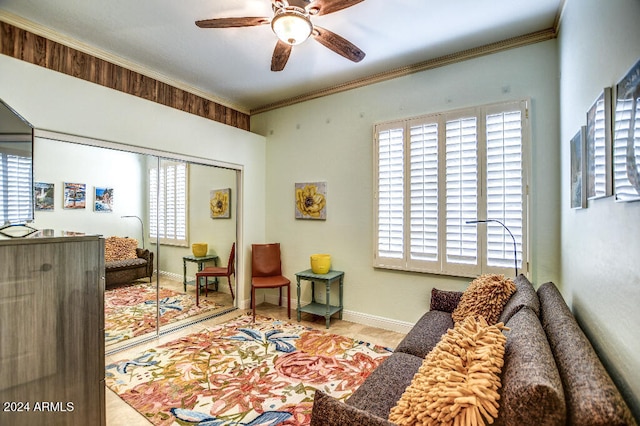 living room with ornamental molding and ceiling fan