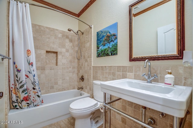 full bathroom featuring tile walls, toilet, ornamental molding, shower / bath combo, and sink