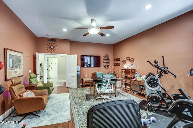 workout area with hardwood / wood-style floors and ceiling fan