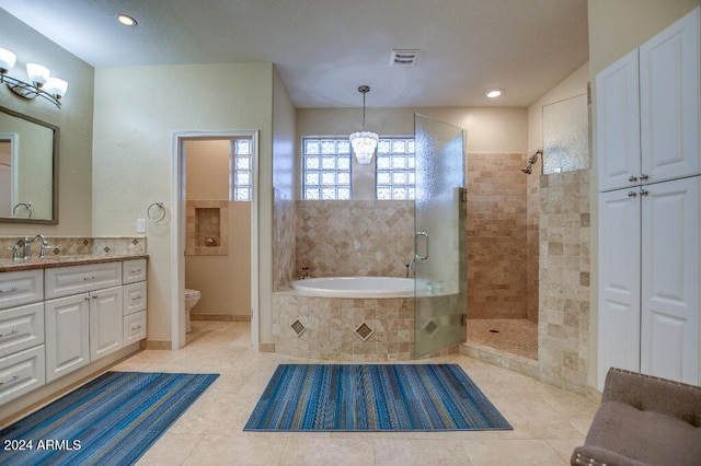 full bathroom featuring a chandelier, toilet, vanity, plus walk in shower, and tile patterned floors