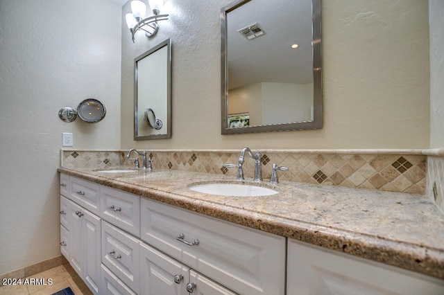 bathroom with vanity, tasteful backsplash, and tile patterned flooring