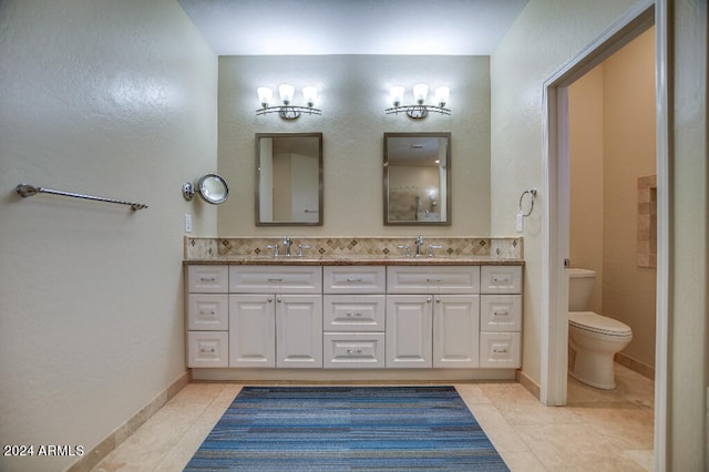 bathroom with vanity, toilet, and tile patterned flooring