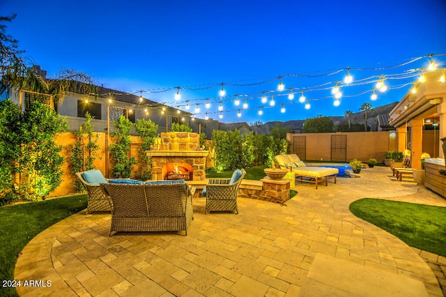 view of patio / terrace featuring an outdoor stone fireplace