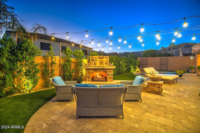 view of patio / terrace with an outdoor living space with a fireplace