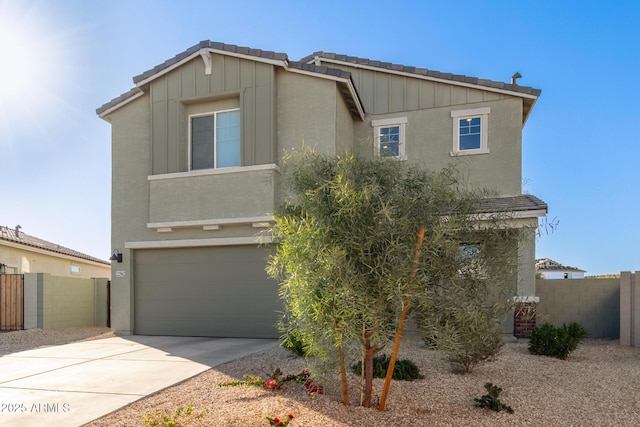 view of front of home featuring concrete driveway, fence, a tiled roof, and stucco siding