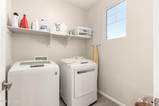 laundry area featuring laundry area, separate washer and dryer, and baseboards