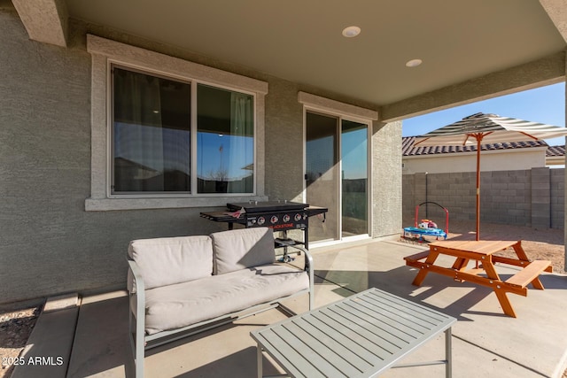 view of patio with outdoor dining area, fence, and an outdoor hangout area