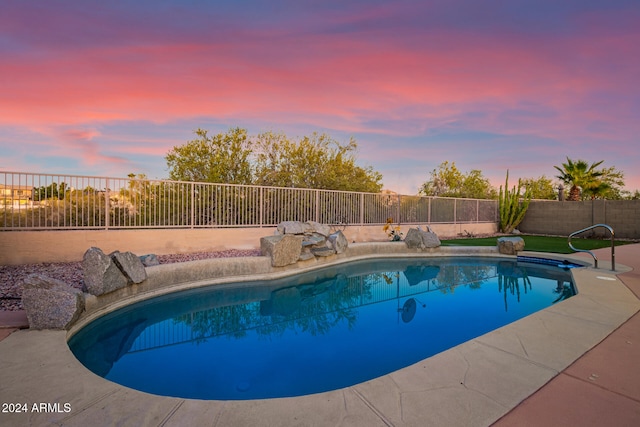 view of pool at dusk