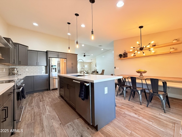 218 N Palm St, Gilbert, AZ 85234 - kitchen with a sink, stainless steel appliances, light wood finished floors, a chandelier, and recessed lighting