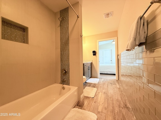 218 N Palm St, Gilbert, AZ 85234 - bathroom featuring hardwood / wood-style flooring, toilet, shower / tub combination, a ceiling fan, and vanity