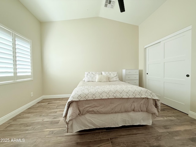 218 N Palm St, Gilbert, AZ 85234 - bedroom with lofted ceiling, light wood-style flooring, baseboards, a closet, and ceiling fan