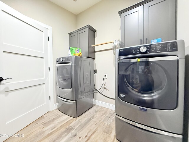 218 N Palm St, Gilbert, AZ 85234 - laundry area featuring cabinet space, washer and dryer, light wood-type flooring, and baseboards