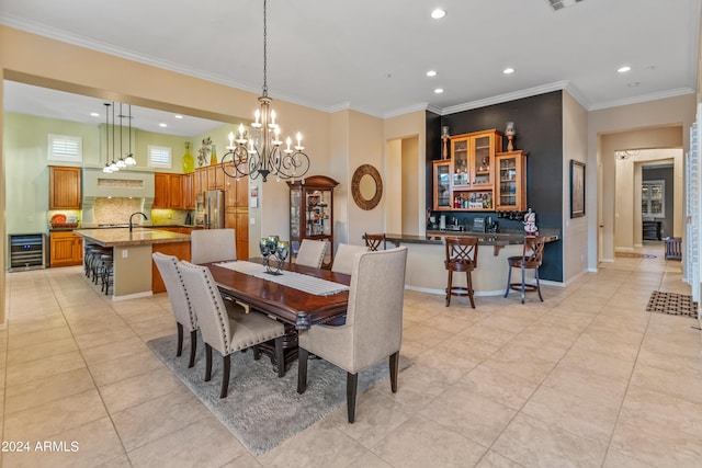 dining room with light tile patterned floors, crown molding, sink, an inviting chandelier, and wine cooler