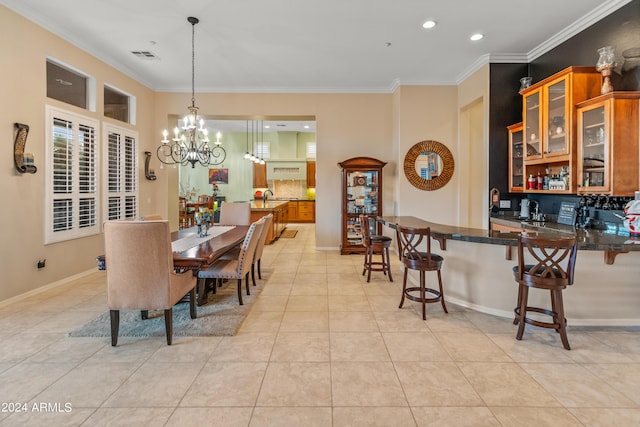 tiled dining area with crown molding and an inviting chandelier