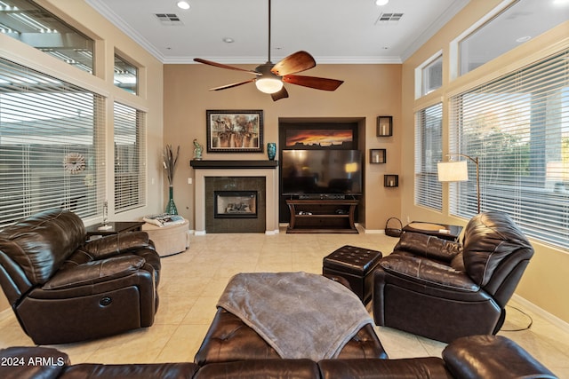 living room featuring light tile patterned floors, crown molding, and ceiling fan