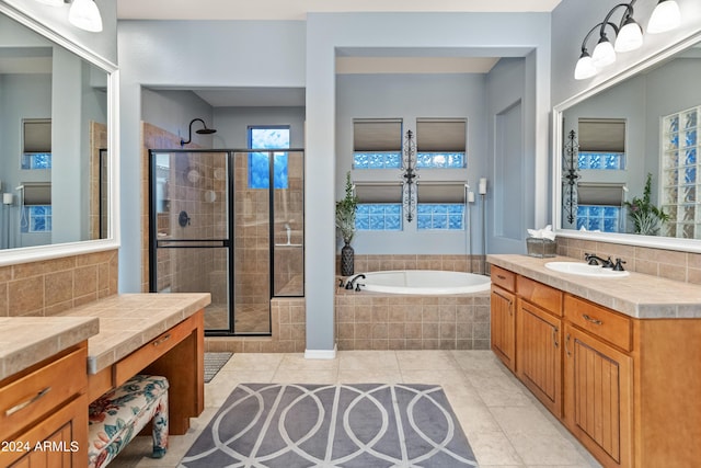 bathroom with tile patterned flooring, vanity, plenty of natural light, and plus walk in shower