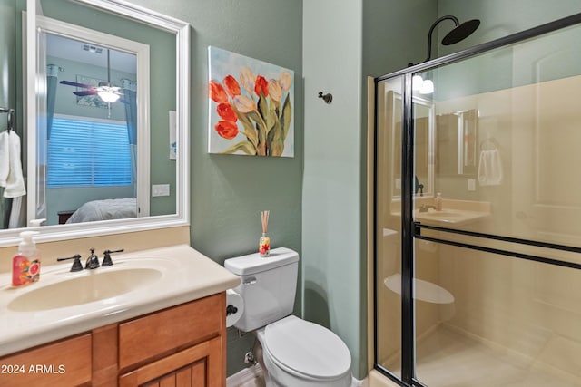 bathroom featuring vanity, toilet, and a shower with shower door