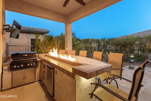 view of patio / terrace with area for grilling and an outdoor fire pit