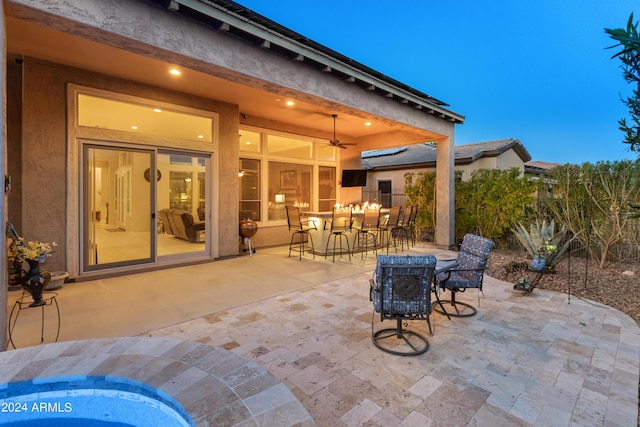 view of patio featuring ceiling fan