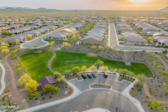 aerial view at dusk featuring a mountain view