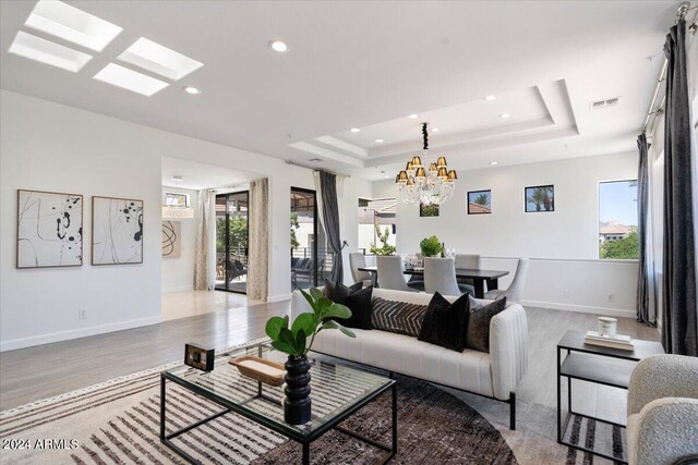 7222 E Gainey Ranch Rd Unit 241, Scottsdale, AZ 85258 - living room featuring plenty of natural light, recessed lighting, baseboards, a chandelier, and wood finished floors