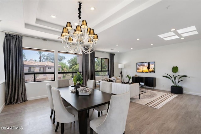 7222 E Gainey Ranch Rd Unit 241, Scottsdale, AZ 85258 - dining room featuring recessed lighting, wood finished floors, baseboards, and a chandelier