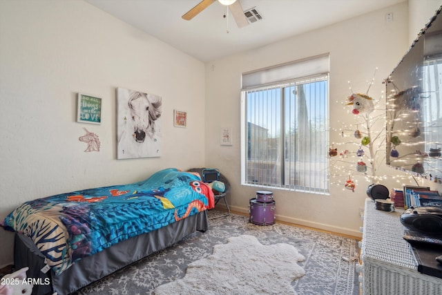 bedroom with a ceiling fan, wood finished floors, visible vents, and baseboards