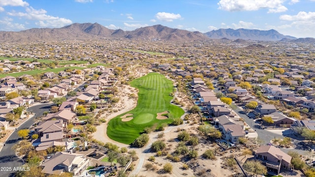 drone / aerial view with view of golf course, a residential view, and a mountain view