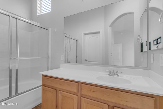 bathroom featuring vanity and combined bath / shower with glass door