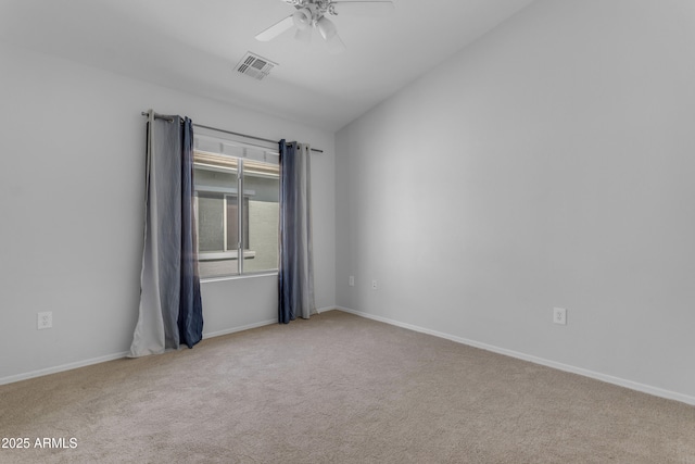 spare room featuring carpet floors, a ceiling fan, and baseboards