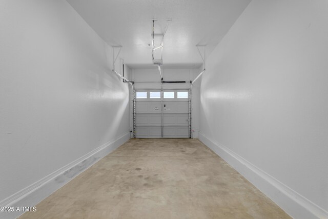 garage with baseboards and a garage door opener