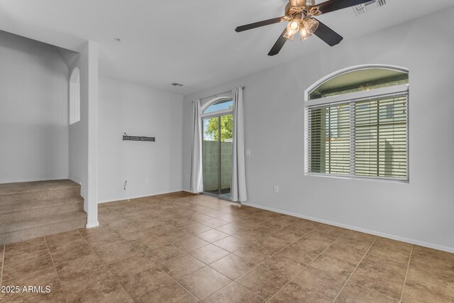 spare room with ceiling fan, baseboards, and tile patterned floors